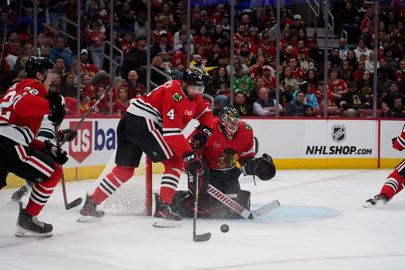 Oct 4, 2024; Chicago, Illinois, USA; Chicago Blackhawks defenseman Seth Jones (4) clears the puck against the Minnesota Wild during the second period at United Center. Mandatory Credit: David Banks-Imagn Images