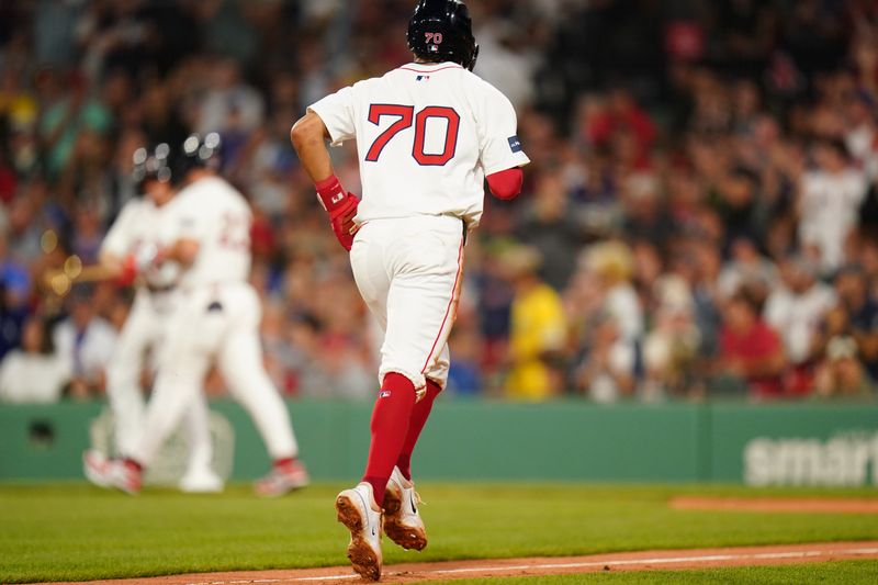 Aug 12, 2024; Boston, Massachusetts, USA; Boston Red Sox first baseman Romy Gonzalez (23) is walked with bases loaded as shortstop David Hamilton (70) is walked home to score against the Texas Rangers in the fifth inning at Fenway Park. Mandatory Credit: David Butler II-USA TODAY Sports