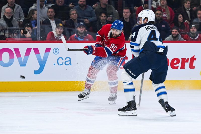 Dec 3, 2025; Montreal, Quebec, CAN; Montreal Canadiens center Joseph Veleno (90) shoots against Winnipeg Jets defenseman Josh Morrissey (44) during the first period at Bell Centre. Mandatory Credit: David Kirouac-Imagn Images
