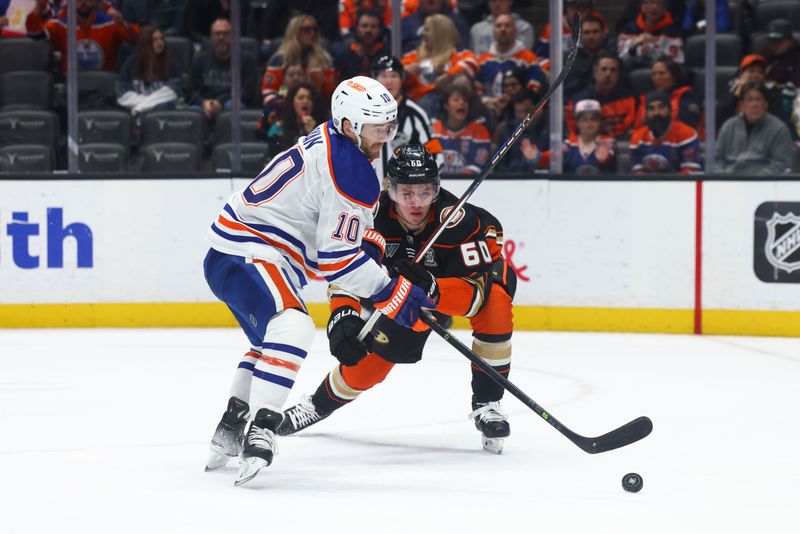 Feb 9, 2024; Anaheim, California, USA; Edmonton Oilers center Derek Ryan (10) skates against Anaheim Ducks defenseman Jackson LaCombe (60) during the first period of a game at Honda Center. Mandatory Credit: Jessica Alcheh-USA TODAY Sports