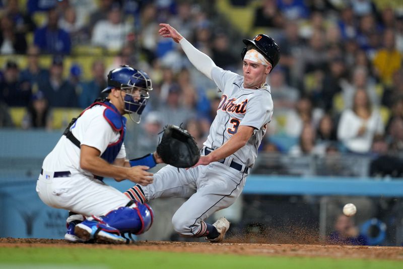 Sep 20, 2023; Los Angeles, California, USA; Detroit Tigers right fielder Kerry Carpenter (30) slides into home plate to beat a throw to Los Angeles Dodgers catcher Austin Barnes (15) to score in the eighth inning at Dodger Stadium. Mandatory Credit: Kirby Lee-USA TODAY Sports