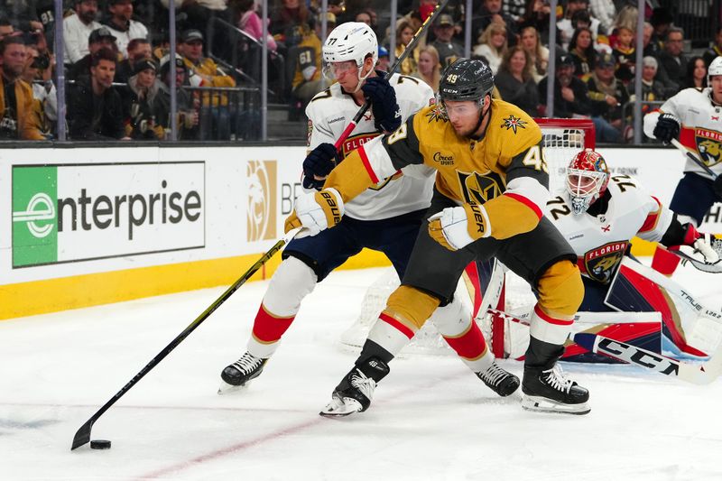 Jan 4, 2024; Las Vegas, Nevada, USA; Vegas Golden Knights center Ivan Barbashev (49) controls the puck around Florida Panthers defenseman Niko Mikkola (77) during the second period at T-Mobile Arena. Mandatory Credit: Stephen R. Sylvanie-USA TODAY Sports