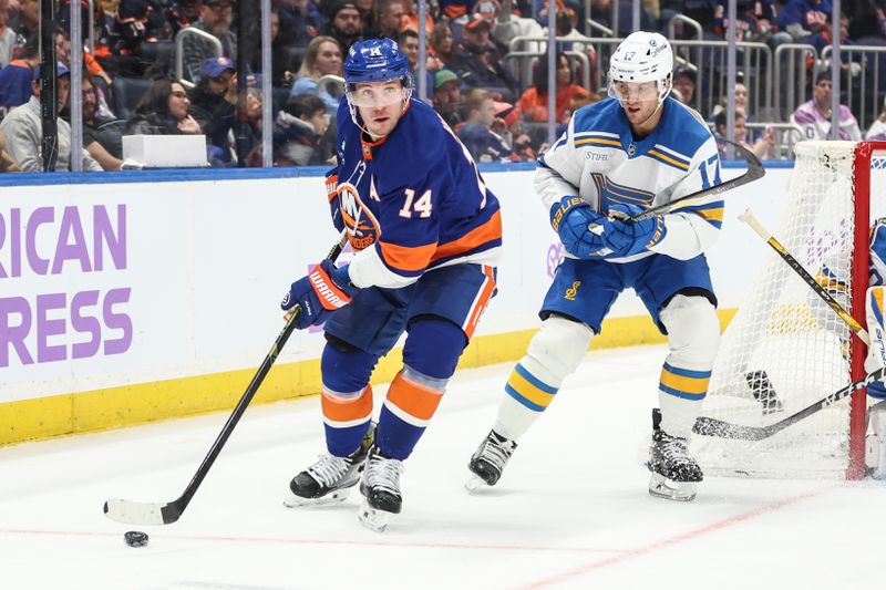 Nov 22, 2025; Elmont, New York, USA; New York Islanders center Bo Horvat (14) and St. Louis Blues defenseman Cam Fowler (17) battle for control of the puck in the second period at UBS Arena. Mandatory Credit: Wendell Cruz-Imagn Images