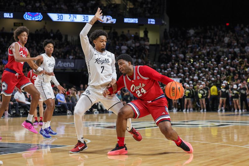 Nov 12, 2024; Orlando, Florida, USA; Florida Atlantic Owls guard KyKy Tandy (24) drives around UCF Knights guard Dior Johnson (7) during the first half at Addition Financial Arena. Mandatory Credit: Mike Watters-Imagn Images