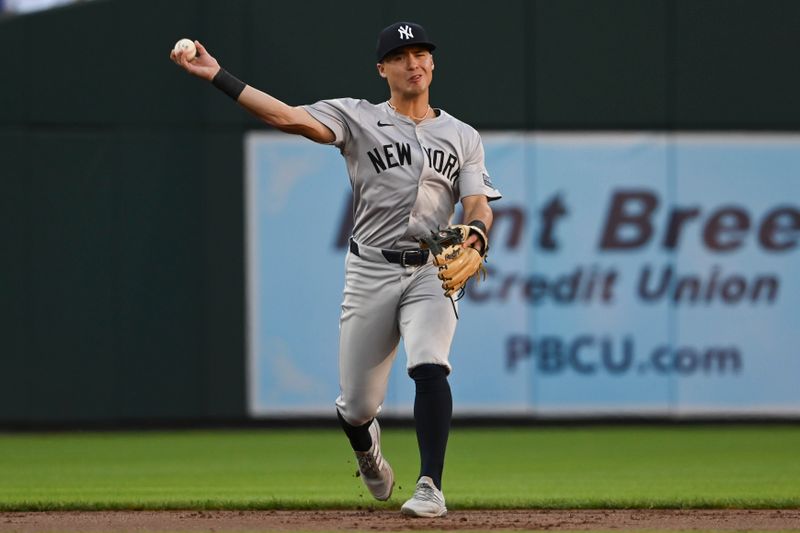 May 1, 2024; Baltimore, Maryland, USA;  New York Yankees shortstop Anthony Volpe (11) throws to first base during the first inning against the Baltimore Orioles at Oriole Park at Camden Yards. Mandatory Credit: Tommy Gilligan-USA TODAY Sports