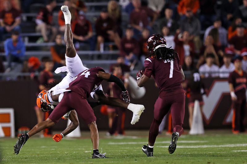 Oct 26, 2023; Blacksburg, Virginia, USA; Syracuse Orange wide receiver Damien Alford (5) is tackled by Virginia Tech Hokies cornerback Dorian Strong (44) during the third quarter at Lane Stadium. Mandatory Credit: Peter Casey-USA TODAY Sports