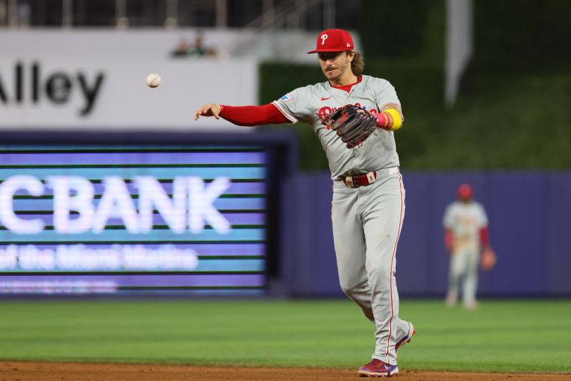 Sep 5, 2024; Miami, Florida, USA; Philadelphia Phillies second baseman Bryson Stott (5) throws to first base to retire Miami Marlins right fielder Jesus Sanchez (not pictured) during the ninth inning at loanDepot Park. Mandatory Credit: Sam Navarro-Imagn Images