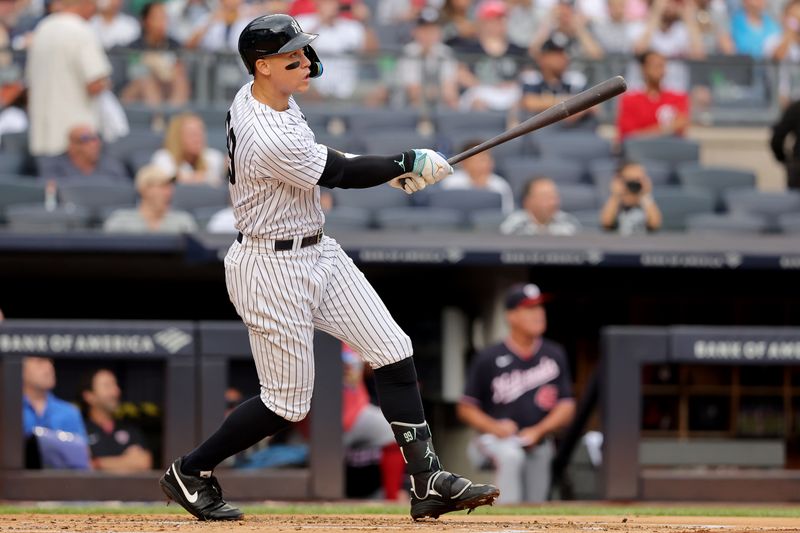 Aug 24, 2023; Bronx, New York, USA; New York Yankees right fielder Aaron Judge (99) follows through on a solo home run against the Washington Nationals during the first inning at Yankee Stadium. Mandatory Credit: Brad Penner-USA TODAY Sports