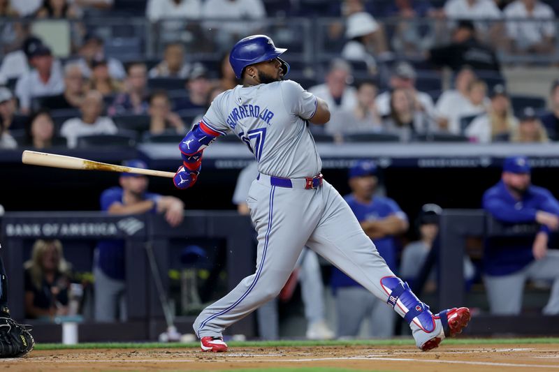 Aug 2, 2024; Bronx, New York, USA; Toronto Blue Jays first baseman Vladimir Guerrero Jr. (27) follows through on an RBI single against the New York Yankees during the first inning at Yankee Stadium. Mandatory Credit: Brad Penner-USA TODAY Sports