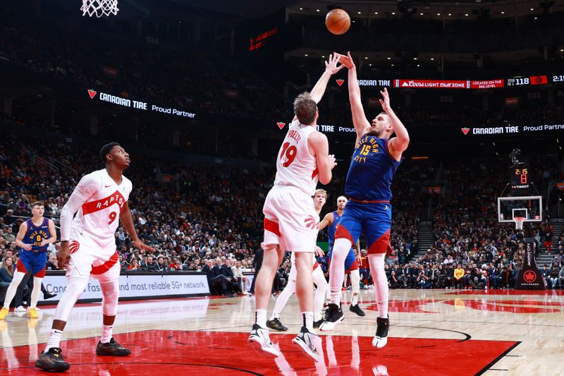 TORONTO, CANADA - OCTOBER 28: Nikola Jokic #15 of the Denver Nuggets shoots the ball during the game against the Toronto Raptors on October 28, 2024 at the Scotiabank Arena in Toronto, Ontario, Canada.  NOTE TO USER: User expressly acknowledges and agrees that, by downloading and or using this Photograph, user is consenting to the terms and conditions of the Getty Images License Agreement.  Mandatory Copyright Notice: Copyright 2024 NBAE (Photo by Vaughn Ridley/NBAE via Getty Images)