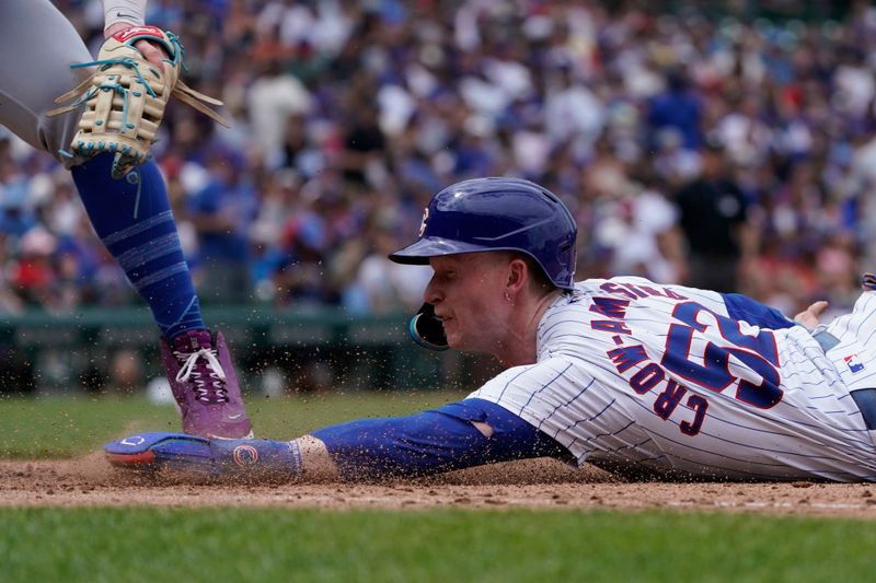 Jun 22, 2024; Chicago, Illinois, USA; Chicago Cubs outfielder Pete Crow-Armstrong (52) dives safely into first base as New York Mets first base Pete Alonso (20) makes a late tag during the sixth inning at Wrigley Field. Mandatory Credit: David Banks-USA TODAY Sports