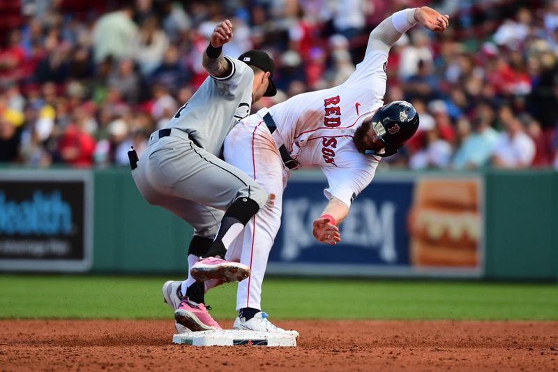 Sep 8, 2024; Boston, Massachusetts, USA;  Boston Red Sox shortstop Trevor Story (10) is tagged out by Chicago White Sox short stop Jacob Amaya (18) trying to steal second base during the third inning at Fenway Park. Mandatory Credit: Bob DeChiara-Imagn Images