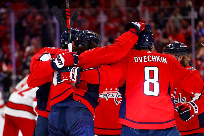 Mar 22, 2024; Washington, District of Columbia, USA; Washington Capitals left wing Sonny Milano (15) celebrates with teammates after scoring a goal past Carolina Hurricanes goaltender Pyotr Kochetkov (not pictured) during the first period at Capital One Arena. Mandatory Credit: Amber Searls-USA TODAY Sports