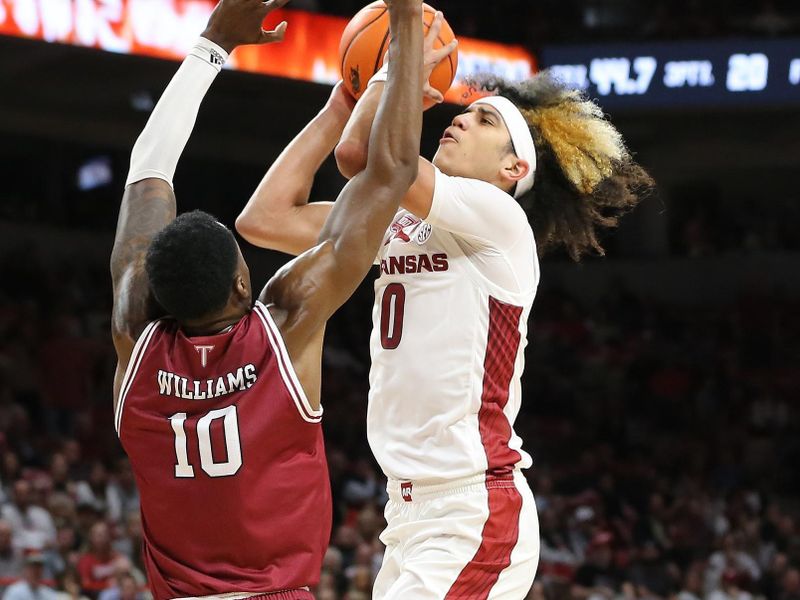 Nov 28, 2022; Fayetteville, Arkansas, USA; Arkansas Razorbacks guard Anthony Black (0) shoots during the second half as Troy Trojans forward Zay Williams (10) defends at Bud Walton Arena. Arkansas won 74-61. Mandatory Credit: Nelson Chenault-USA TODAY Sports