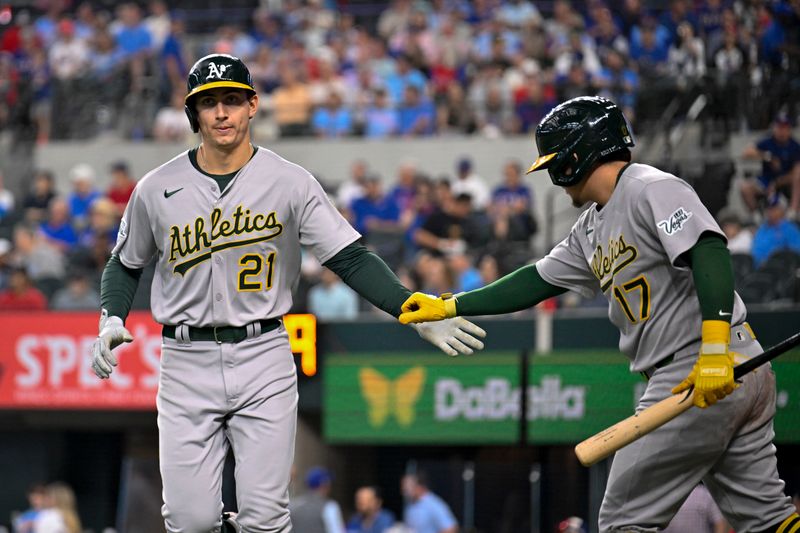 May 1, 2025; Arlington, Texas, USA; Athletics left fielder Tyler Soderstrom (21) and second baseman Luis Urías (17) celebrates a run scored by Soderstrom against the Texas Rangers during the first inning at Globe Life Field. Mandatory Credit: Jerome Miron-Imagn Images