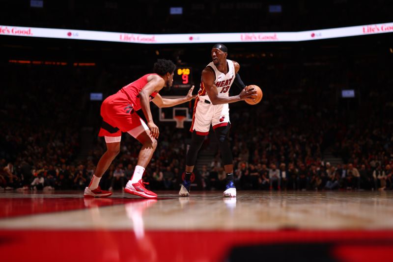 TORONTO, CANADA - JANUARY 17: Bam Adebayo #13 of the Miami Heat looks to pass the ball during the game against the Toronto Raptors on January 17, 2024 at the Scotiabank Arena in Toronto, Ontario, Canada.  NOTE TO USER: User expressly acknowledges and agrees that, by downloading and or using this Photograph, user is consenting to the terms and conditions of the Getty Images License Agreement.  Mandatory Copyright Notice: Copyright 2024 NBAE (Photo by Vaughn Ridley/NBAE via Getty Images)