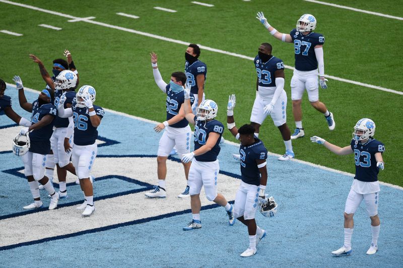 Oct 10, 2020; Chapel Hill, North Carolina, USA; North Carolina Tar Heels players signal that it is the fourth quarter at Kenan Memorial Stadium. Mandatory Credit: Bob Donnan-USA TODAY Sports