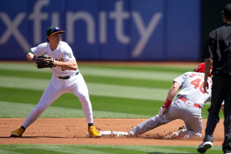 Apr 17, 2024; Oakland, California, USA; Oakland Athletics second baseman Zack Gelof (20) forces out St. Louis Cardinals first baseman Paul Goldschmidt (46) at second base before throwing to first for a double play during the first inning at Oakland-Alameda County Coliseum. Mandatory Credit: D. Ross Cameron-USA TODAY Sports