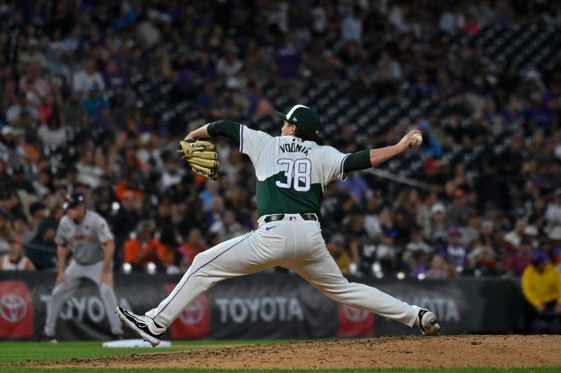 Jul 20, 2024; Denver, Colorado, USA; Colorado Rockies pitcher Victor Vodnik (38) delivers a pitch against the San Francisco Giants in the ninth inning at Coors Field. Mandatory Credit: John Leyba-USA TODAY Sports