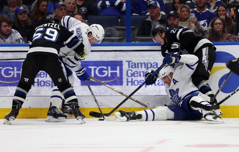 Nov 30, 2024; Tampa, Florida, USA;Toronto Maple Leafs center John Tavares (91), Toronto Maple Leafs right wing Mitch Marner (16), Tampa Bay Lightning center Jake Guentzel (59) and center Brayden Point (21) fight to control the puck during the second period at Amalie Arena. Mandatory Credit: Kim Klement Neitzel-Imagn Images