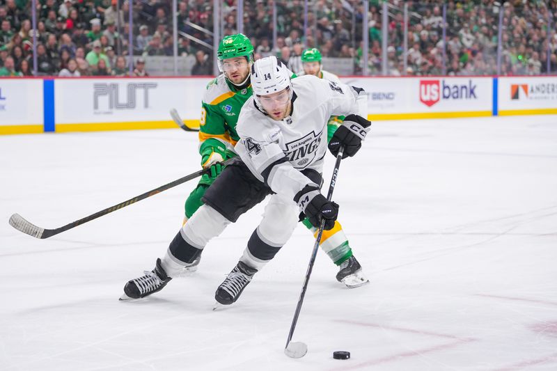Mar 17, 2025; Saint Paul, Minnesota, USA;  Los Angeles Kings right wing Alex Laferriere (14) skates with the puck against the Minnesota Wild in the third period at Xcel Energy Center. Mandatory Credit: Brad Rempel-Imagn Images
