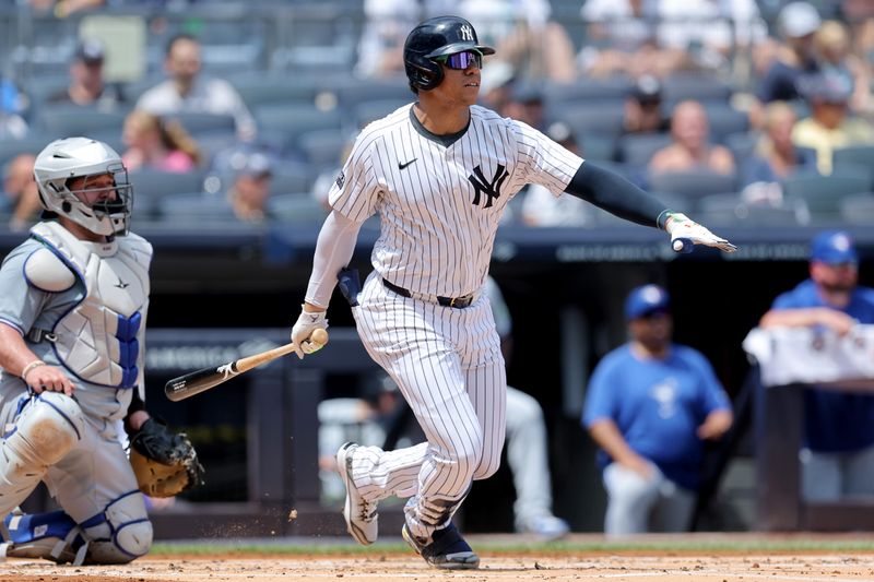 Aug 3, 2024; Bronx, New York, USA; New York Yankees right fielder Juan Soto (22) follows through on a single against the Toronto Blue Jays during the first inning at Yankee Stadium. Mandatory Credit: Brad Penner-USA TODAY Sports