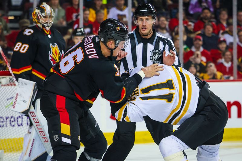 Feb 28, 2023; Calgary, Alberta, CAN; Boston Bruins center Trent Frederic (11) and Calgary Flames defenseman Nikita Zadorov (16) fight during the first period at Scotiabank Saddledome. Mandatory Credit: Sergei Belski-USA TODAY Sports