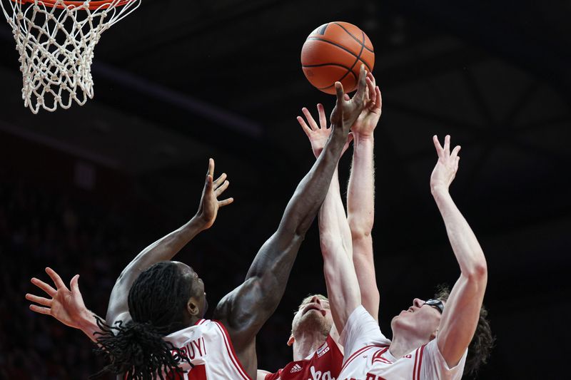 Jan 17, 2024; Piscataway, New Jersey, USA; Rutgers Scarlet Knights center Clifford Omoruyi (11) and guard Gavin Griffiths (10) battle for a rebound against Nebraska Cornhuskers forward Rienk Mast (51) during the first half at Jersey Mike's Arena. Mandatory Credit: Vincent Carchietta-USA TODAY Sports