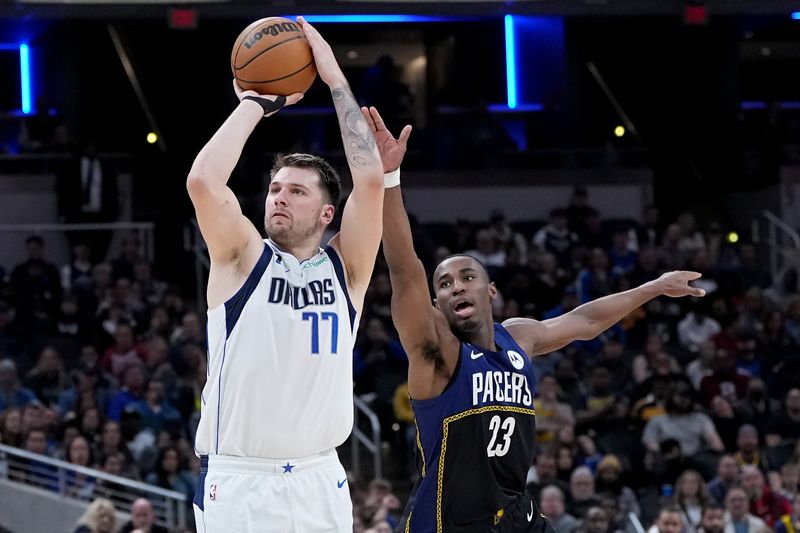 INDIANAPOLIS, INDIANA - MARCH 27: Luka Doncic #77 of the Dallas Mavericks attempts a shot while being guarded by Aaron Nesmith #23 of the Indiana Pacers in the third quarter at Gainbridge Fieldhouse on March 27, 2023 in Indianapolis, Indiana. NOTE TO USER: User expressly acknowledges and agrees that, by downloading and or using this photograph, User is consenting to the terms and conditions of the Getty Images License Agreement. (Photo by Dylan Buell/Getty Images)