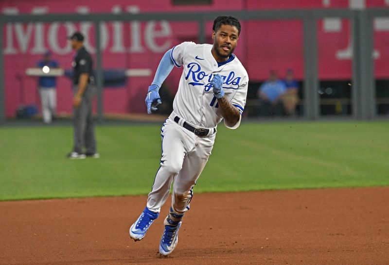 Jun 14, 2023; Kansas City, Missouri, USA;  Kansas City Royals Maikel Garcia (11) triples in the seventh inning against the Cincinnati Reds at Kauffman Stadium. Mandatory Credit: Peter Aiken-USA TODAY Sports