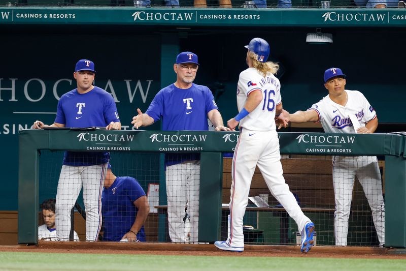 Sep 4, 2024; Arlington, Texas, USA; Texas Rangers outfielder Travis Jankowski (16) is greeted by coaches after scoring a run during the fourth inning against the New York Yankees at Globe Life Field. Mandatory Credit: Andrew Dieb-Imagn Images