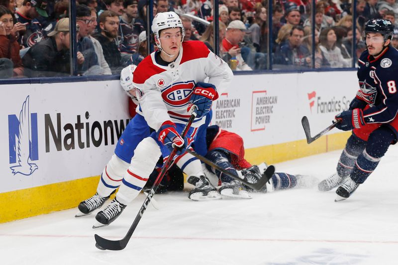 Nov 27, 2024; Columbus, Ohio, USA; Montreal Canadiens center Jake Evans (71) controls the puck against the Columbus Blue Jackets during the third period at Nationwide Arena. Mandatory Credit: Russell LaBounty-Imagn Images