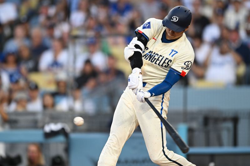 Jun 22, 2024; Los Angeles, California, USA; Los Angeles Dodgers designated hitter Shohei Ohtani (17) hits a home run against the Los Angeles Angels during the third inning at Dodger Stadium. Mandatory Credit: Jonathan Hui-USA TODAY Sports