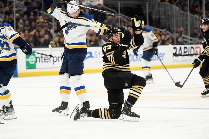 Mar 11, 2024; Boston, Massachusetts, USA;  St. Louis Blues center Oskar Sundqvist (70) gets a penalty for hooking on Boston Bruins defenseman Charlie McAvoy (73) during the second period at TD Garden. Mandatory Credit: Bob DeChiara-USA TODAY Sports