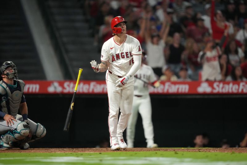 Aug 31, 2024; Anaheim, California, USA; Los Angeles Angels center fielder Mickey Moniak (16) hits a walk-off home run in the ninth inning as Seattle Mariners catcher Cal Raleigh (29) watches at Angel Stadium. Mandatory Credit: Kirby Lee-USA TODAY Sports