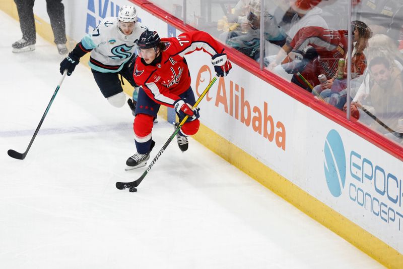 Jan 11, 2024; Washington, District of Columbia, USA; Washington Capitals right wing T.J. Oshie (77) skates with the puck as Seattle Kraken center Yanni Gourde (37) chases in the second period at Capital One Arena. Mandatory Credit: Geoff Burke-USA TODAY Sports