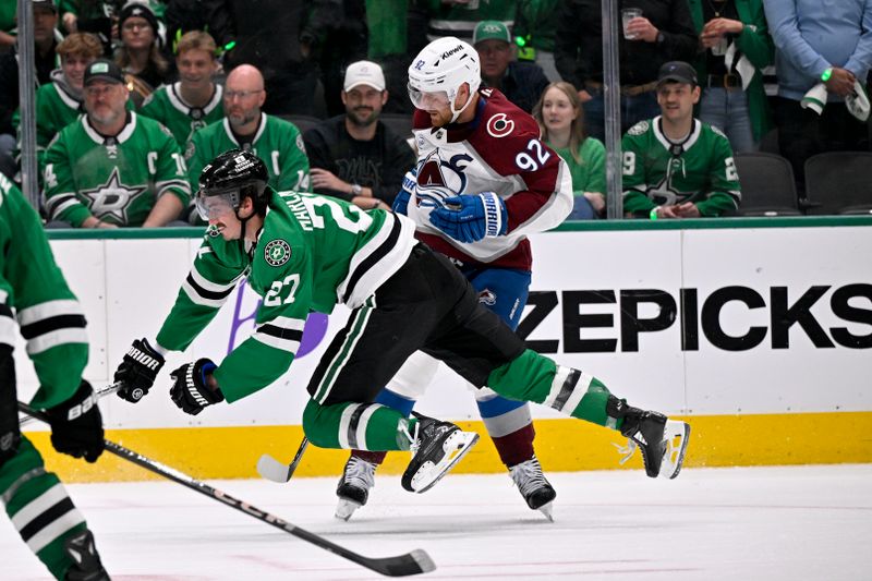 Apr 28, 2025; Dallas, Texas, USA; Colorado Avalanche left wing Gabriel Landeskog (92) checks Dallas Stars left wing Mason Marchment (27) during the third period in game five of the first round of the 2025 Stanley Cup Playoffs at American Airlines Center. Mandatory Credit: Jerome Miron-Imagn Images