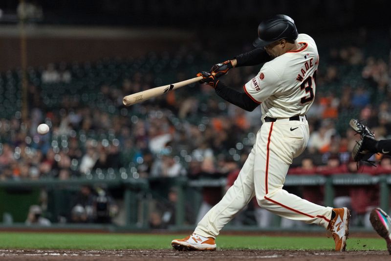 Sep 4, 2024; San Francisco, California, USA;  San Francisco Giants first base LaMonte Wade Jr. (31) hits a two RBI single during the ninth inning against the Arizona Diamondbacks at Oracle Park. Mandatory Credit: Stan Szeto-Imagn Images