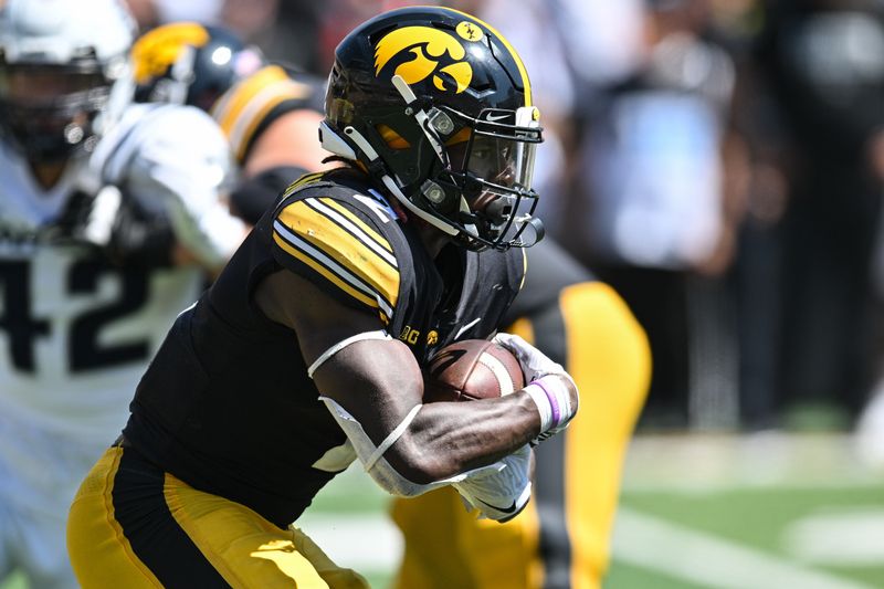 Sep 2, 2023; Iowa City, Iowa, USA; Iowa Hawkeyes running back Kaleb Johnson (2) runs the ball against the Utah State Aggies during the third quarter at Kinnick Stadium. Mandatory Credit: Jeffrey Becker-USA TODAY Sports