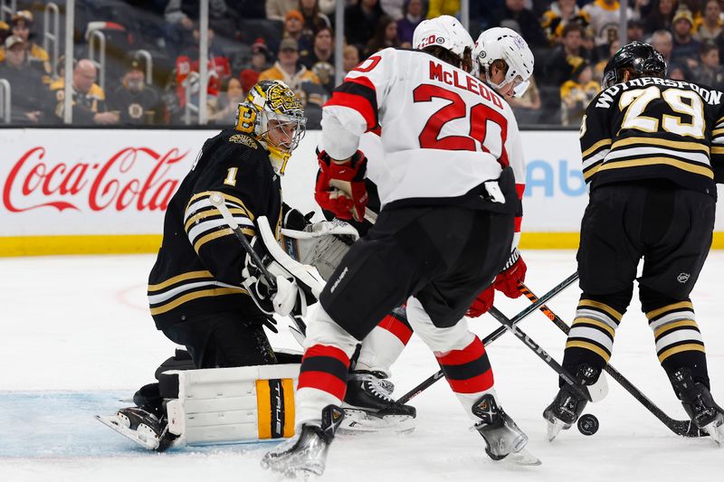 Jan 15, 2024; Boston, Massachusetts, USA; Boston Bruins goaltender Jeremy Swayman (1) keeps his eye on a loose puck in front during the second period against the New Jersey Devils at TD Garden. Mandatory Credit: Winslow Townson-USA TODAY Sports