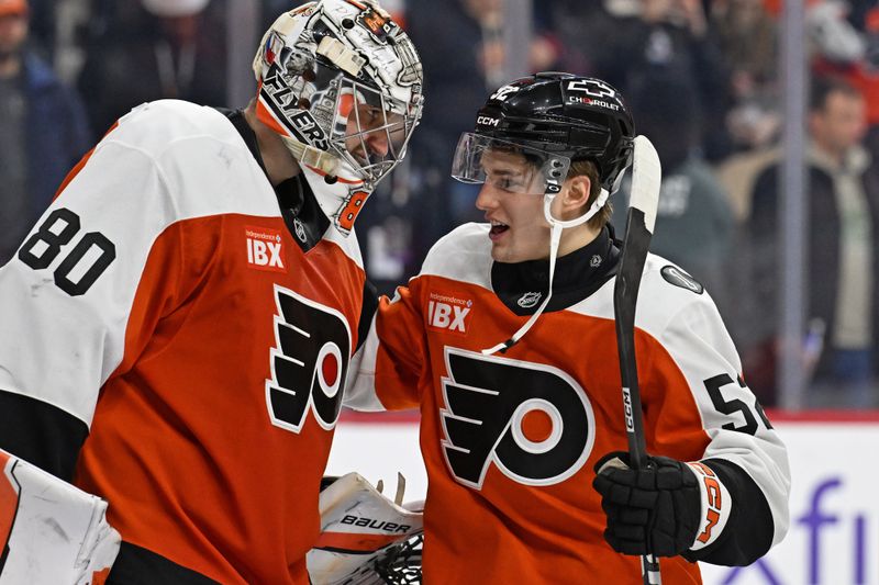 Dec 22, 2025; Philadelphia, Pennsylvania, USA; Philadelphia Flyers goaltender Dan Vladar (80) and center Denver Barkey (52) celebrate win against the Vancouver Canucks at Xfinity Mobile Arena. Mandatory Credit: Eric Hartline-Imagn Images