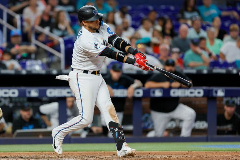 Jun 4, 2023; Miami, Florida, USA; Miami Marlins first baseman Yuli Gurriel (10) hits a single against the Oakland Athletics during the seventh inning at loanDepot Park. Mandatory Credit: Sam Navarro-USA TODAY Sports