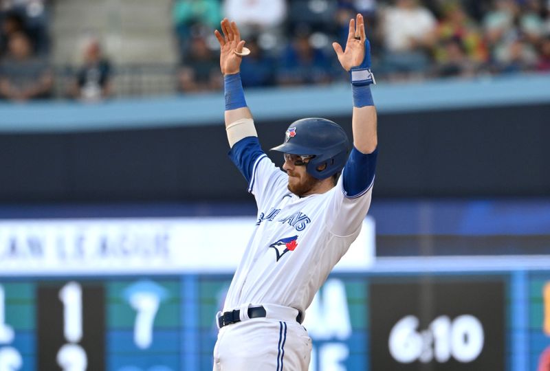 May 13, 2023; Toronto, Ontario, CAN; Toronto Blue Jays catcher Danny Jansen (9) reacts after hitting an RBI double against the Atlanta Braves in the eighth inning at Rogers Centre. Mandatory Credit: Dan Hamilton-USA TODAY Sports