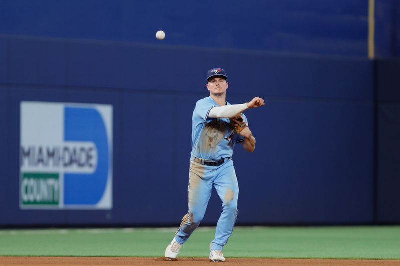 Jun 21, 2023; Miami, Florida, USA; Toronto Blue Jays third baseman Matt Chapman (26) throws the baseball to first baseman Vladimir Guerrero Jr. (not pictured) to retire Miami Marlins designated hitter Jorge Soler (not pictured) during the seventh inning at loanDepot Park. Mandatory Credit: Sam Navarro-USA TODAY Sports