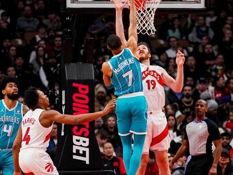 TORONTO, ON - DECEMBER 18: Bryce McGowens #7 of the Charlotte Hornets goes to the basket against Jakob Poeltl #19 of the Toronto Raptors during first half NBA action at Scotiabank Arena on December 18, 2023 in Toronto, Ontario, Canada. NOTE TO USER: User expressly acknowledges and agrees that, by downloading and/or using this Photograph, user is consenting to the terms and conditions of the Getty Images License Agreement. (Photo by Andrew Lahodynskyj/Getty Images)