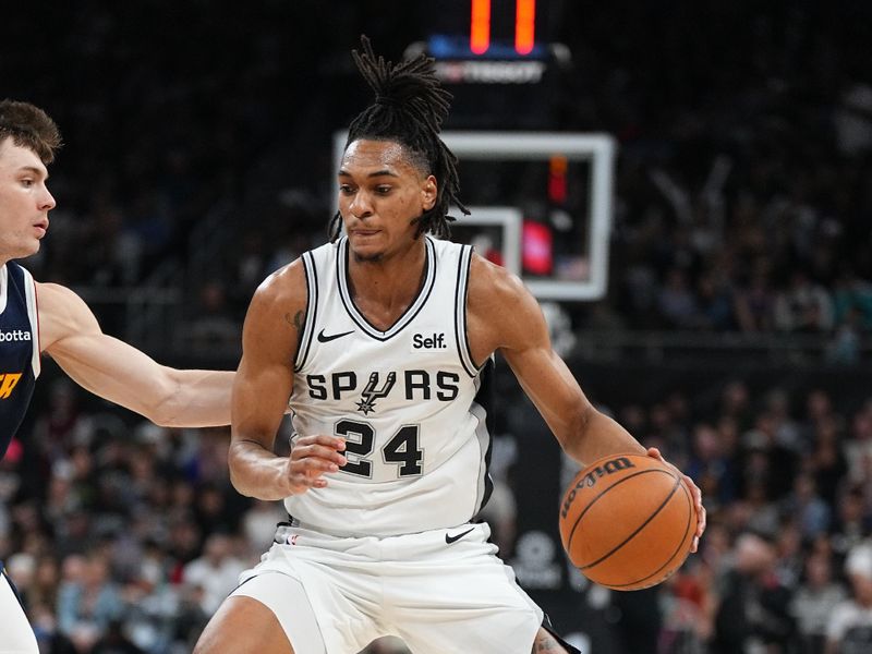 AUSTIN, TX - MARCH 15: Devin Vassell #24 of the San Antonio Spurs dribbles the ball during the game against the Denver Nuggets on March 15, 2024 at the Moody Center in Austin, Texas. NOTE TO USER: User expressly acknowledges and agrees that, by downloading and/or using this Photograph, user is consenting to the terms and conditions of the Getty Images License Agreement. Mandatory Copyright Notice: Copyright 2024 NBAE (Photo by Garrett Ellwood/NBAE via Getty Images)