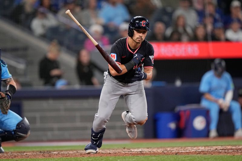 May 4, 2025; Toronto, Ontario, CAN; Cleveland Guardians left fielder Steven Kwan (38) tosses his bat as he is walked during the ninth inning against the Toronto Blue Jays at Rogers Centre. Mandatory Credit: John E. Sokolowski-Imagn Images
