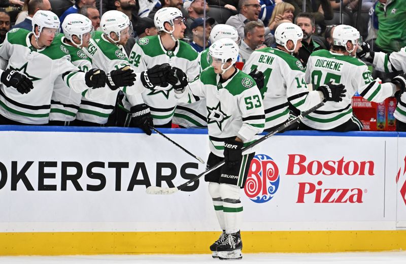 Feb 7, 2024; Toronto, Ontario, CAN; Dallas Stars forward Wyatt Johnston (53) celebrates with team mats at the bench after scoring against the Toronto Maple Leafs in the third period at Scotiabank Arena. Mandatory Credit: Dan Hamilton-USA TODAY Sports