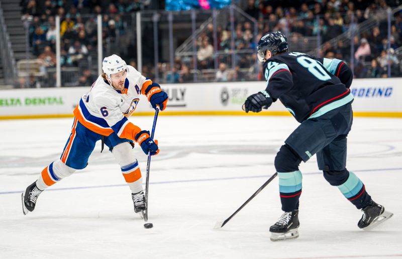 Jan 21, 2026; Seattle, Washington, USA; New York Islandersdefenseman Ryan Pulock (6) shoots the puck against Seattle Kraken forward Kaapo Kakko (84) during the third period at Climate Pledge Arena. Mandatory Credit: Stephen Brashear-Imagn Images