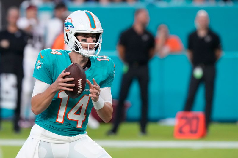 Miami Dolphins quarterback Mike White looks for an opening during the first half of a preseason NFL football game against the Atlanta Falcons, Friday, Aug. 11, 2023, in Miami Gardens, Fla. (AP Photo/Wilfredo Lee)